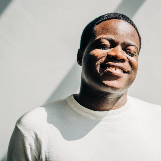 close up of happy black man with closed eyes