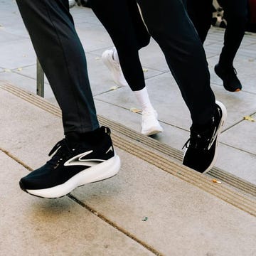 People running on a pavement wearing contemporary athletic shoes.