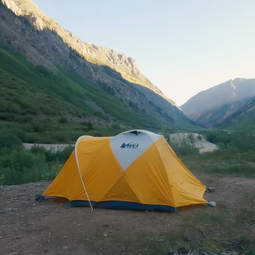 Campsite in a mountainous landscape with tents.